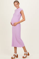 woman wearing a lavender ribbed maternity dress and holding her baby bump