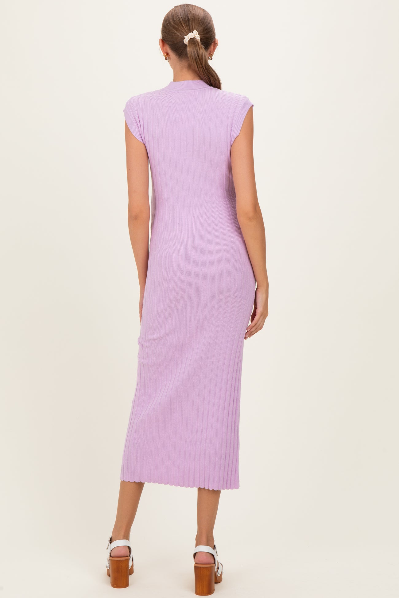 woman wearing a lavender ribbed knit maternity dress with cap sleeves, showing a fitted silhouette and mid-calf length
