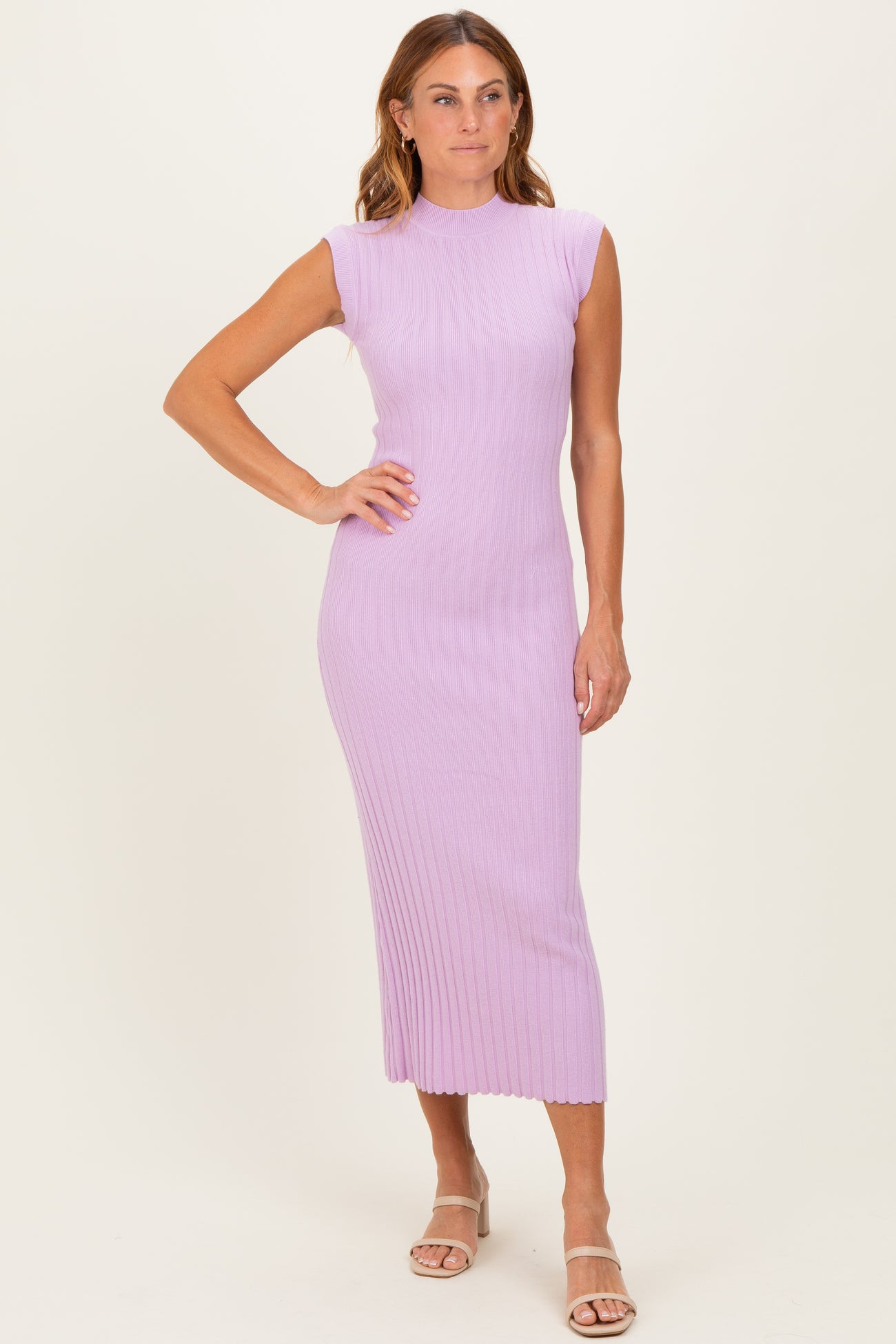 woman wearing a lavender ribbed midi dress with short sleeves and a fitted silhouette