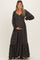 woman wearing a black floral maternity maxi dress and holding her baby bump