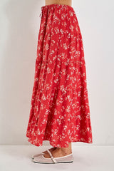 woman wearing a red floral tiered maxi skirt with an elastic drawstring waist and white flats