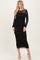 woman wearing a black long sleeve mesh dress with floral embroidery and a ruched bodycon fit