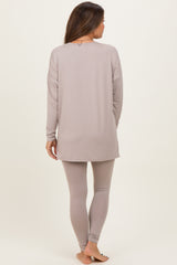 woman wearing a light gray long sleeve maternity top and matching leggings, showing a comfortable and relaxed fit from the back