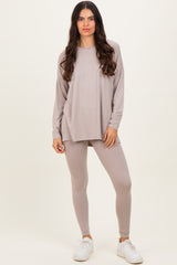 woman wearing a light taupe long sleeve top and matching leggings with white sneakers