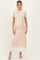 woman wearing a light pink ribbed maternity dress with a tie waist and white hem, featuring a visible baby bump