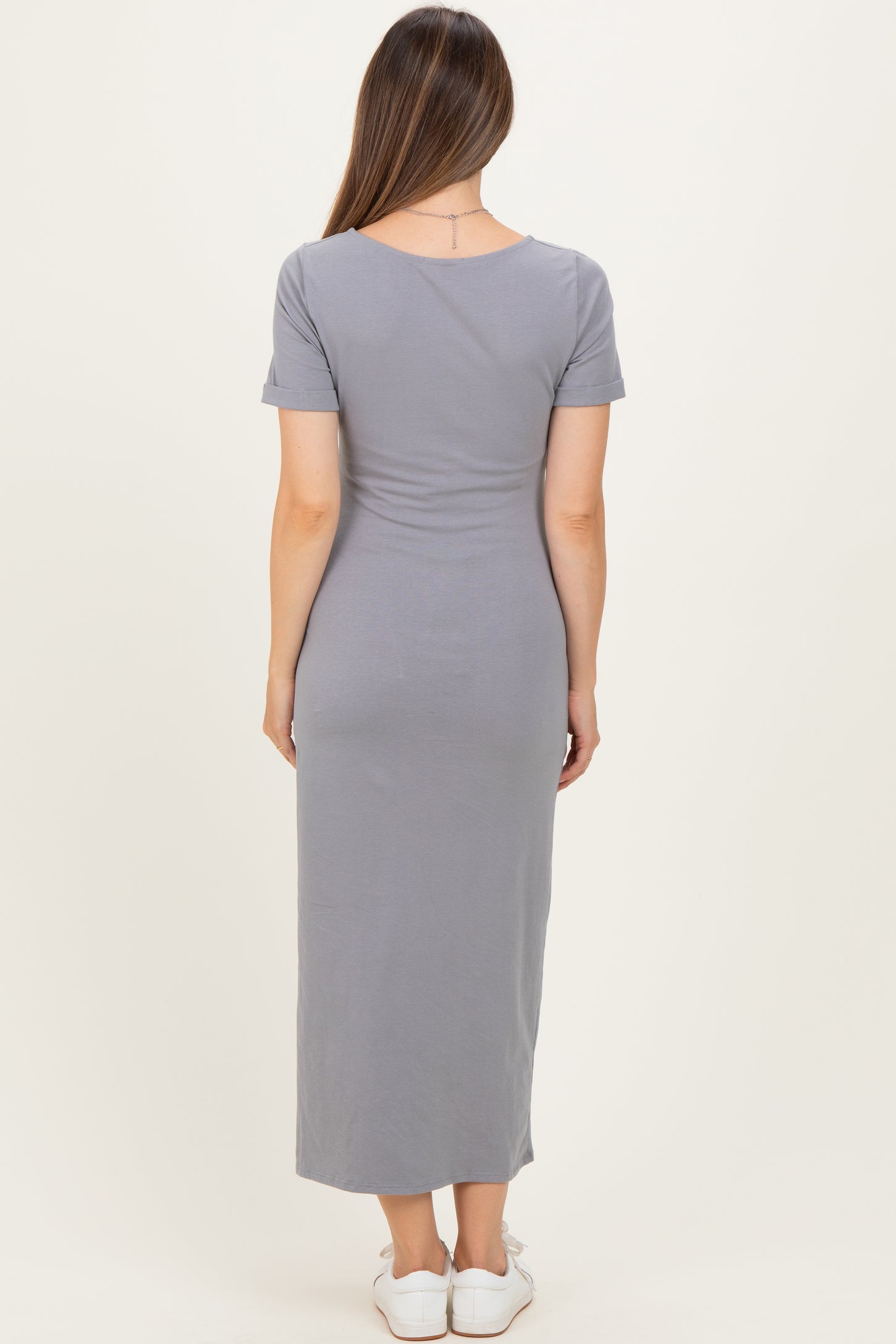 woman wearing a gray short sleeve maternity maxi dress, viewed from the back