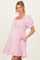 woman wearing a pink puff sleeve maternity dress with a square neckline, cinched waist, and pockets, showing her baby bump