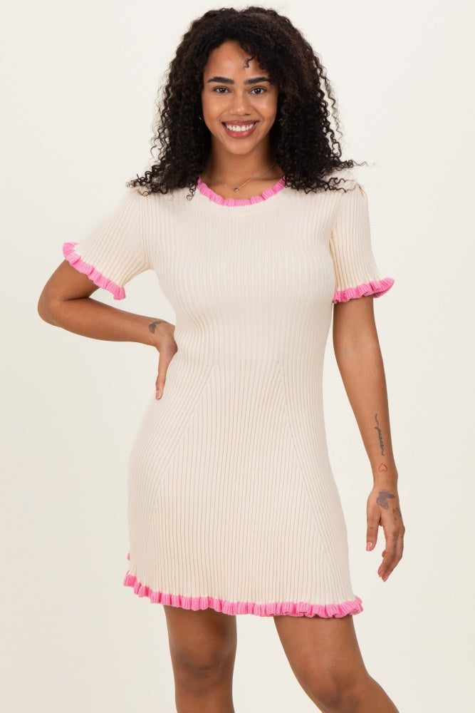 woman wearing a cream short sleeve ribbed dress with pink ruffled trim