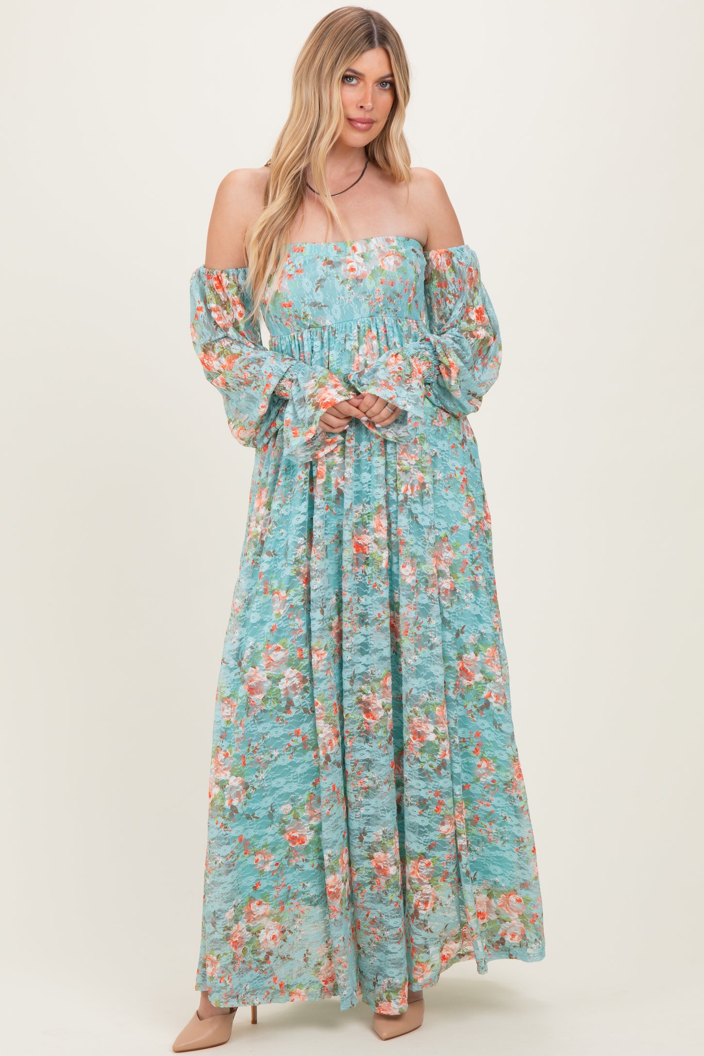 woman wearing a light blue off-the-shoulder floral maxi dress with full sleeves and a smocked bodice