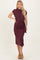 woman wearing a burgundy short sleeve wrap dress with a side tie detail and a midi length
