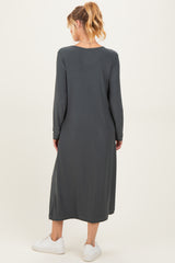 woman wearing a dark gray long sleeve maternity dress, shown from the back with a relaxed fit and ankle length