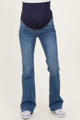 woman wearing blue maternity bootcut jeans with a navy over-the-belly panel