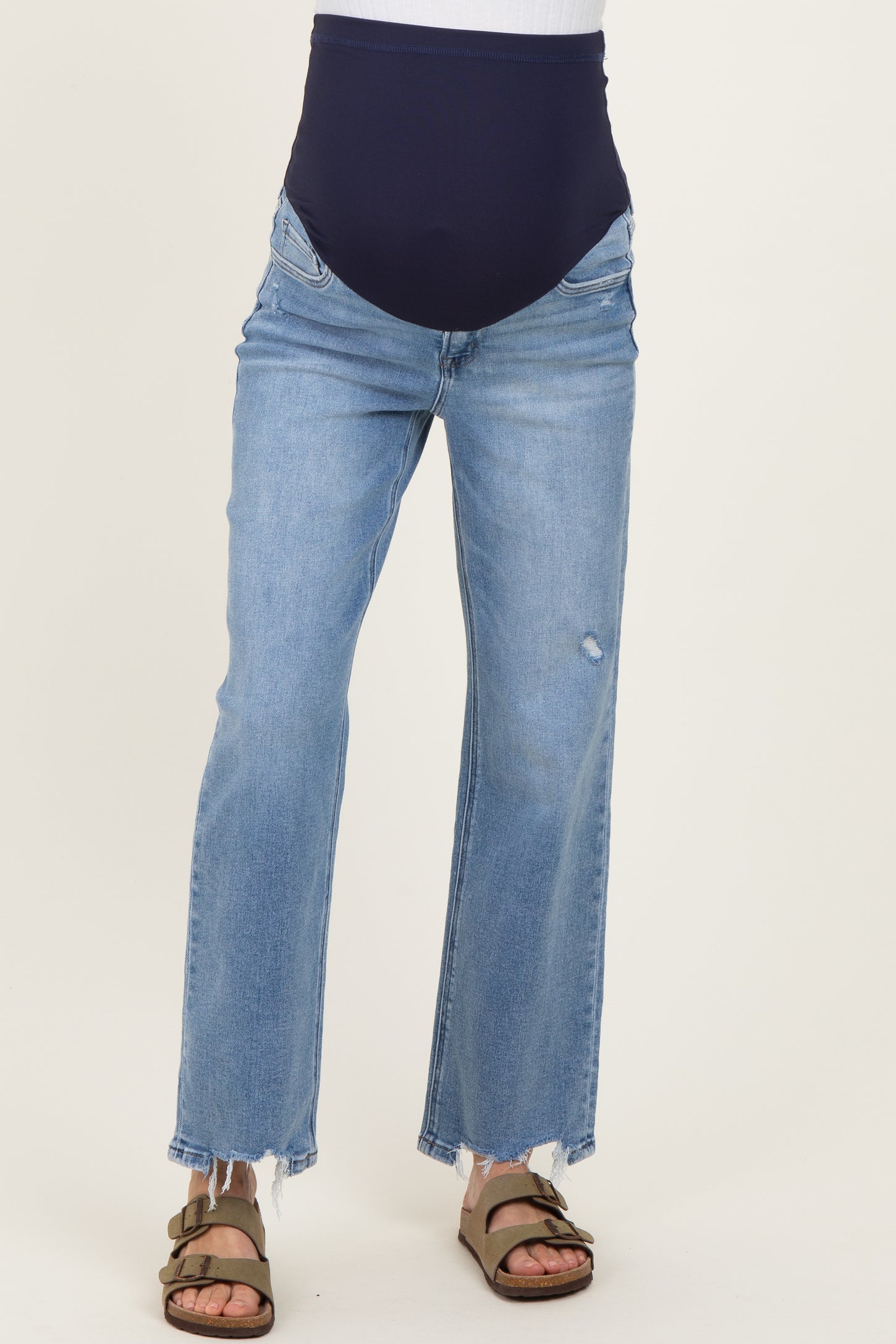 woman wearing light blue maternity jeans with a navy blue over-the-bump waistband and frayed hems