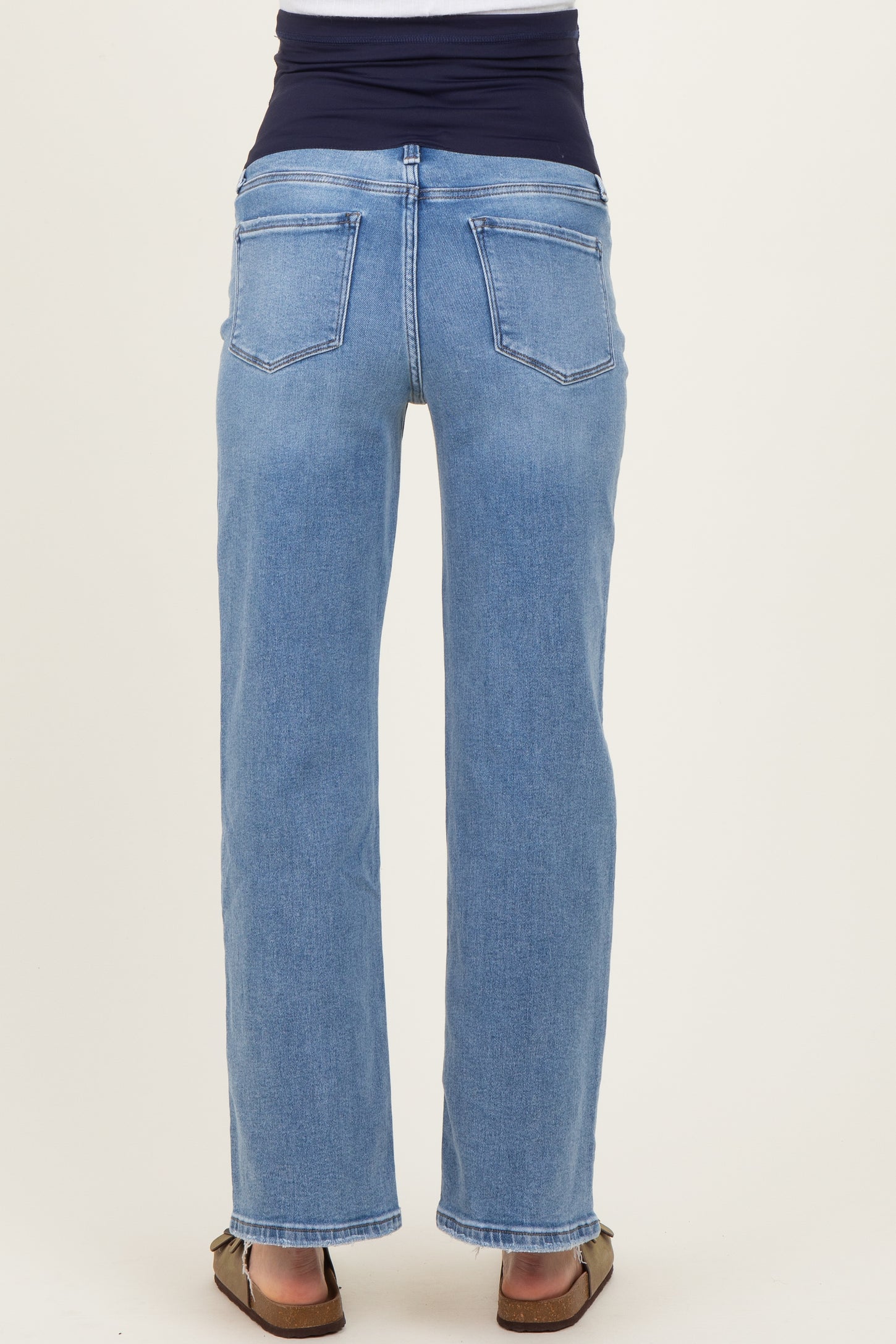 maternity wear blue denim jeans with a wide black waistband, shown from the back