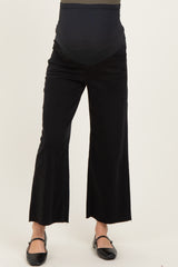 woman wearing black wide-leg maternity jeans with a high waist and stretchy panel for comfort