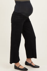 woman wearing black maternity wide leg jeans with a supportive belly panel and a visible baby bump