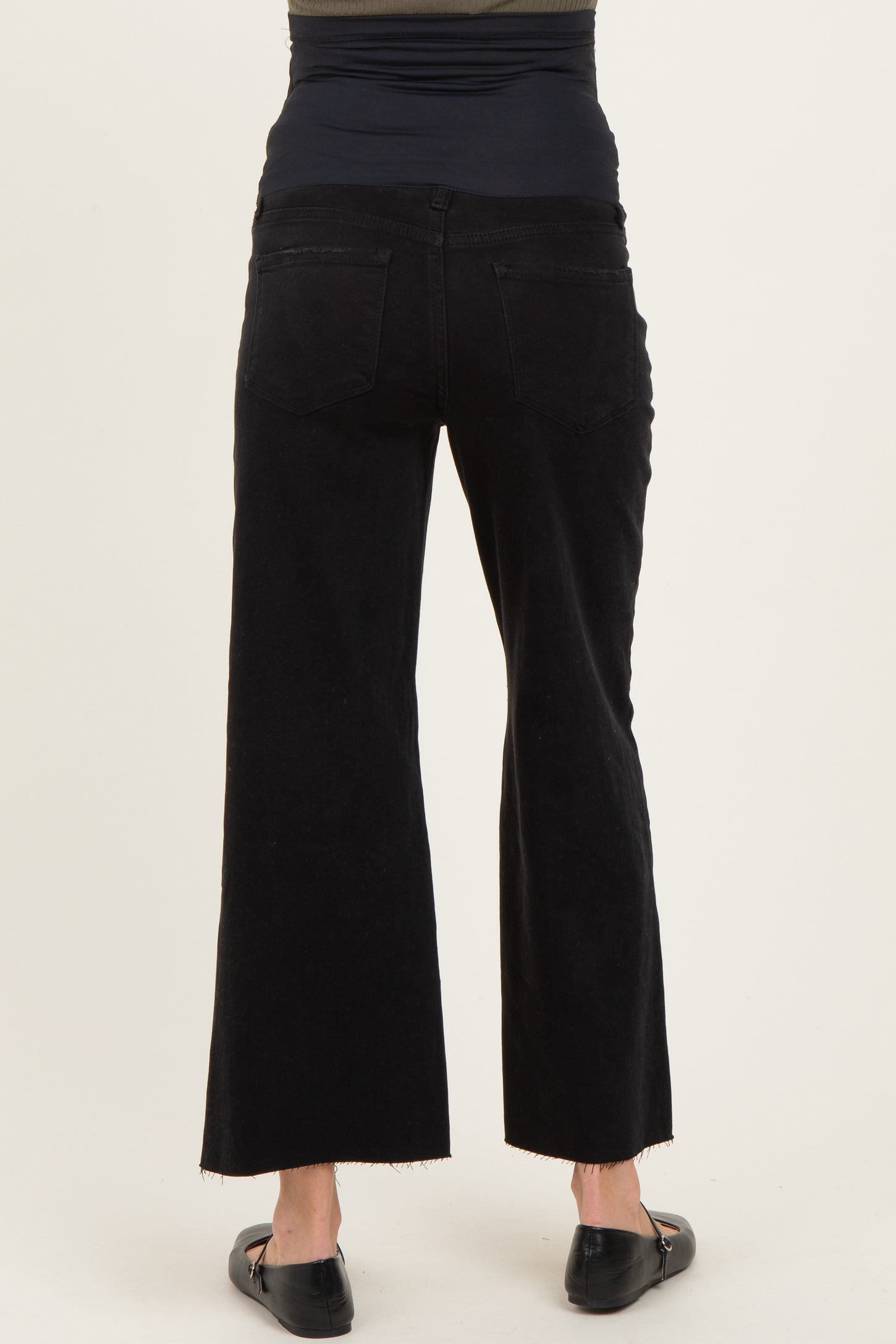 woman wearing black maternity wide-leg pants with a high waistband, viewed from the back
