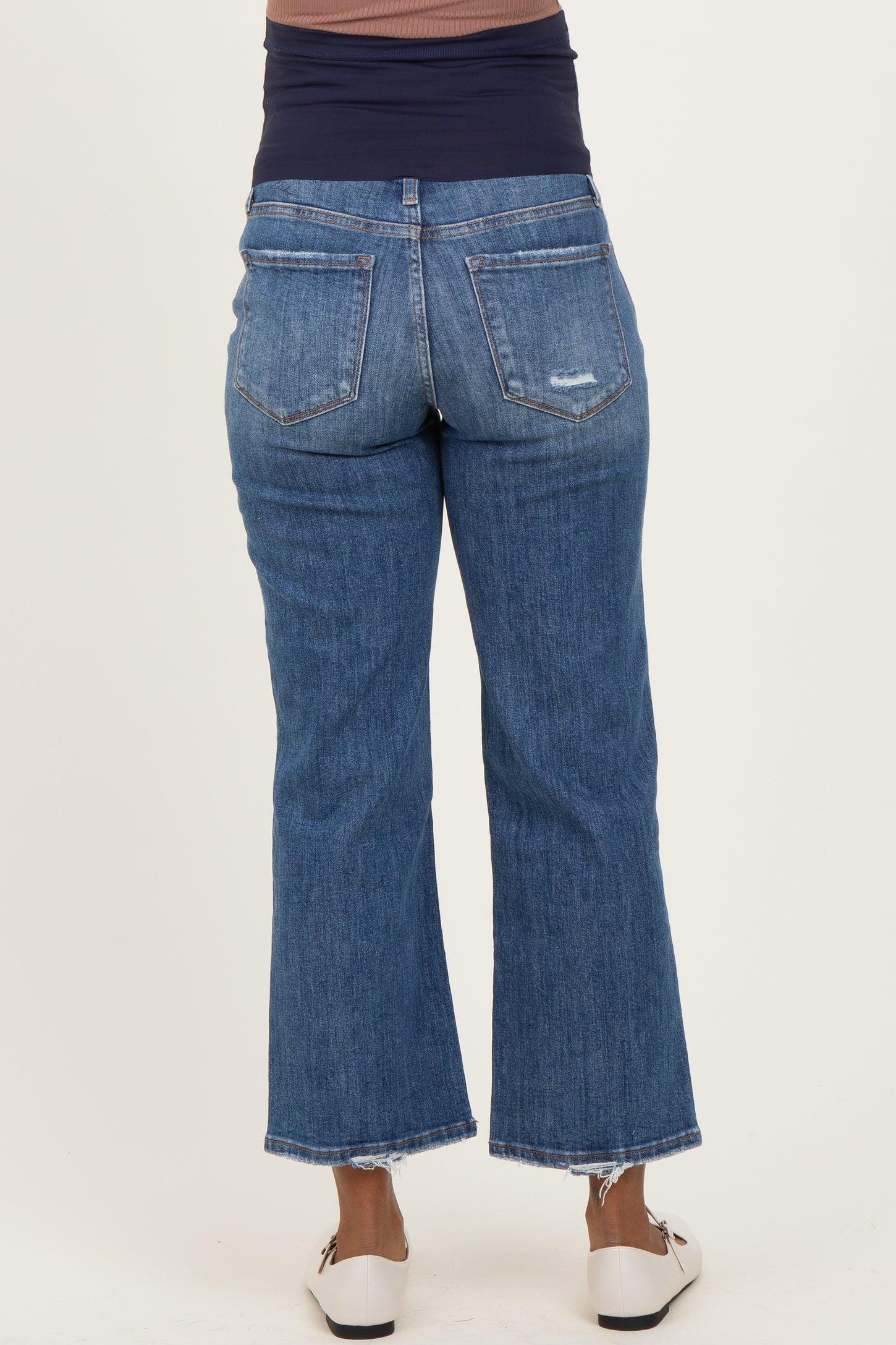 maternity wear dark wash flare jeans with a stretchy navy waistband, shown from the back