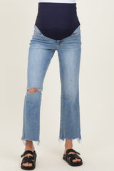 woman wearing a pair of distressed light blue maternity jeans with a dark blue over-the-bump waistband