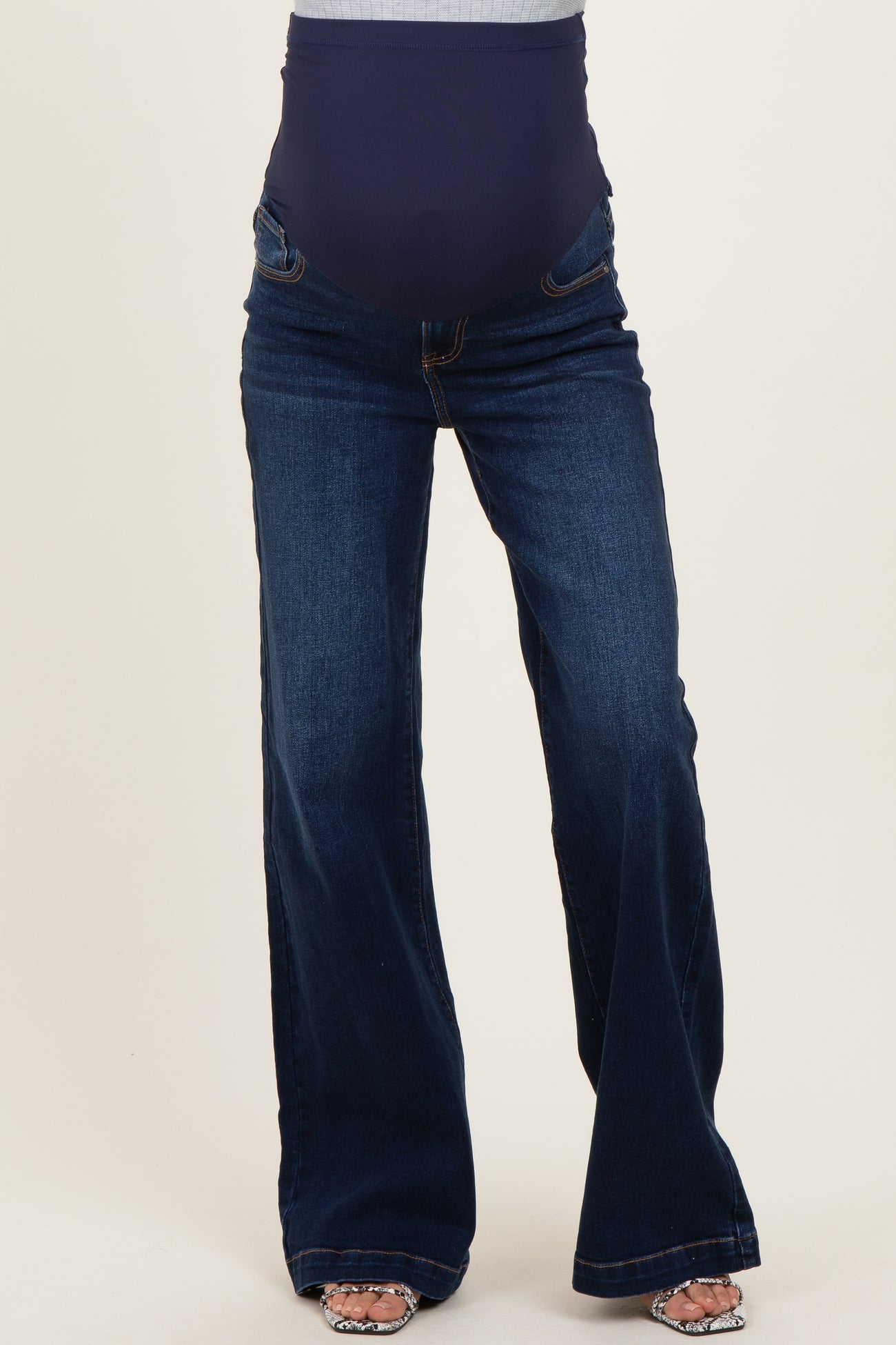 woman wearing dark blue maternity flare jeans with a high stretch panel for comfort and support