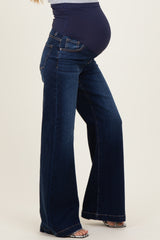 woman wearing dark wash maternity straight leg jeans with a supportive belly panel and a visible baby bump
