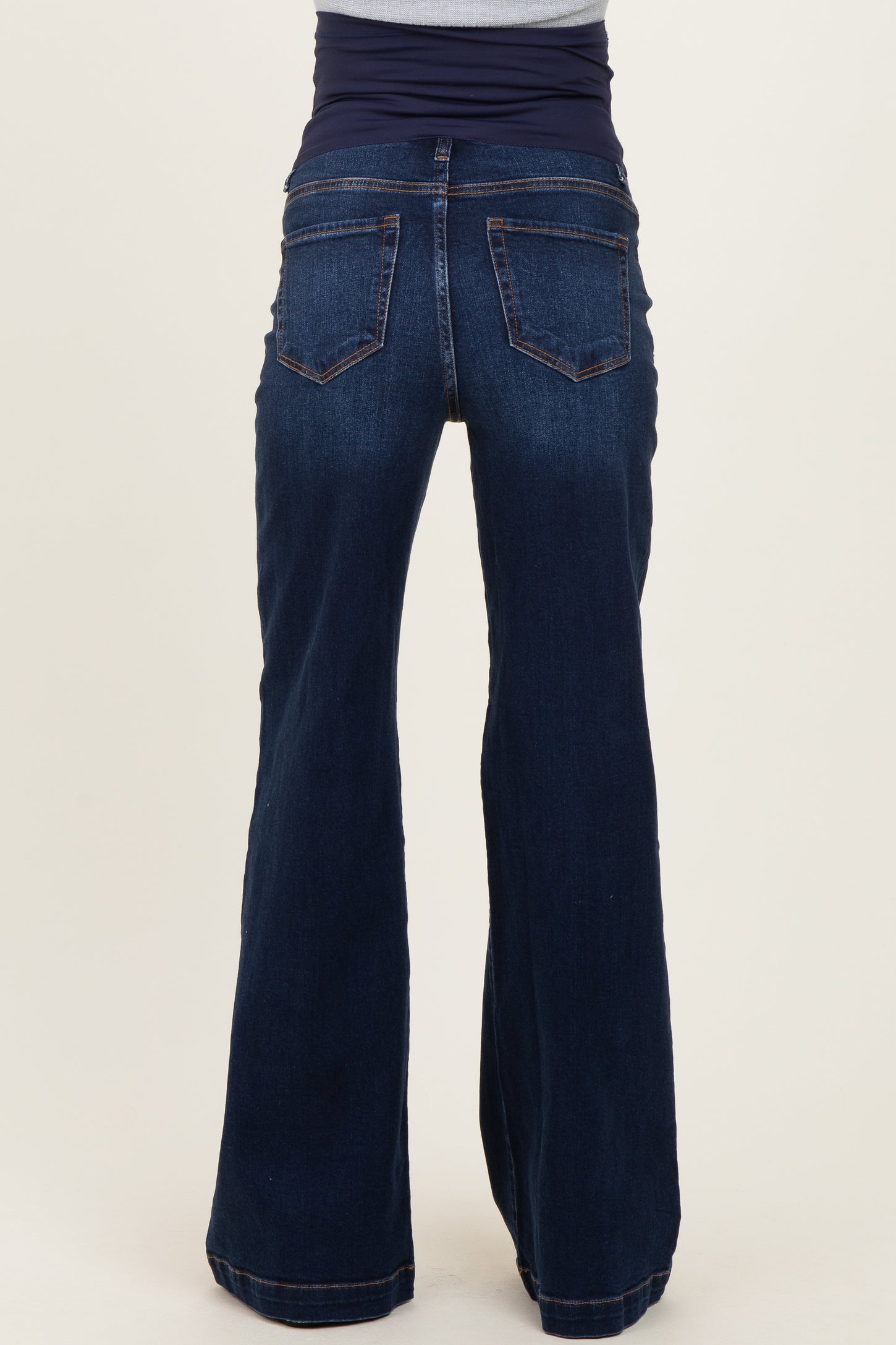 maternity wear dark blue flared jeans with a stretchy waistband, model shown from the back
