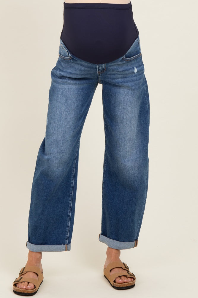 woman wearing a pair of blue maternity jeans with a rolled cuff and a stretchy navy waistband