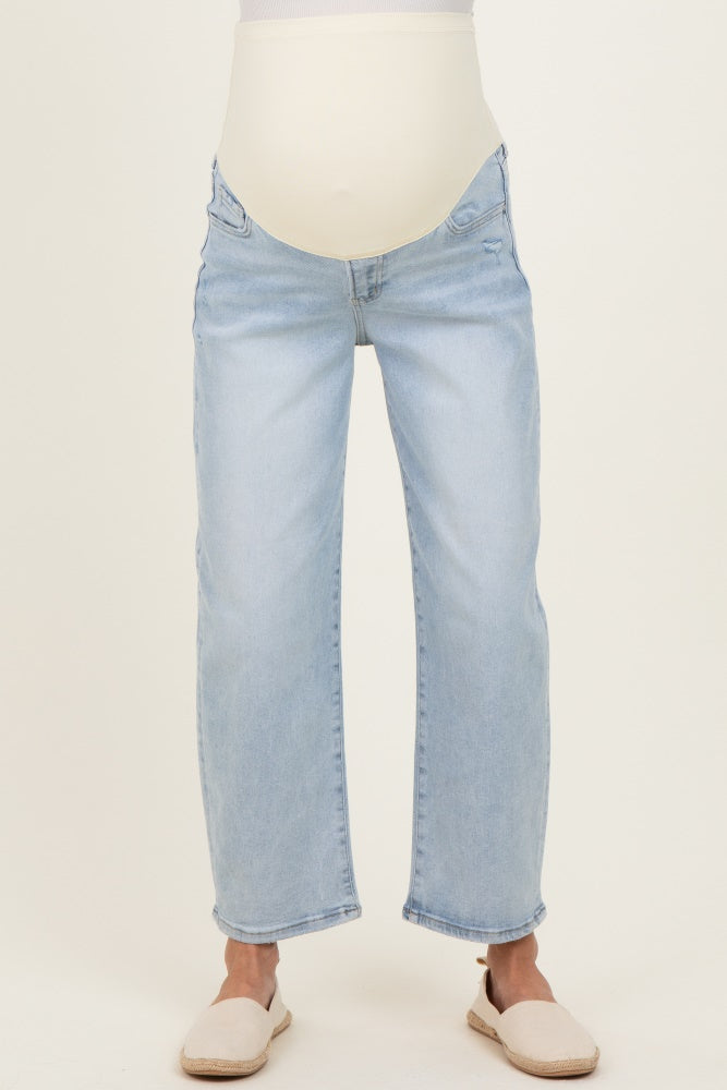 maternity wear light blue distressed jeans with a supportive waistband, model wearing sandals