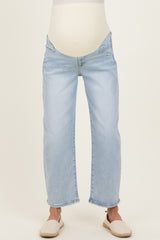 maternity wear light blue distressed jeans with a supportive waistband, model wearing sandals