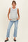 woman wearing a striped maternity tank top and light blue jeans, showing her baby bump
