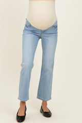 woman wearing light blue maternity jeans with a fitted waistband and a straight leg silhouette
