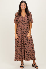 woman wearing a brown floral maxi dress with puff sleeves and a v-neckline