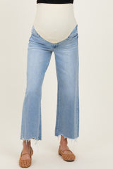 maternity wear light wash flared jeans with a cream colored over-the-bump panel and distressed hem