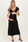 woman wearing a black maternity dress with short puff sleeves and holding her baby bump