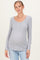 woman wearing a light gray long sleeve maternity top with a scoop neckline and button details, showing a baby bump