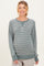 woman wearing a green striped maternity sweatshirt with long sleeves and a relaxed fit, showing her baby bump