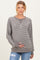 woman wearing a gray striped maternity sweatshirt and holding her baby bump