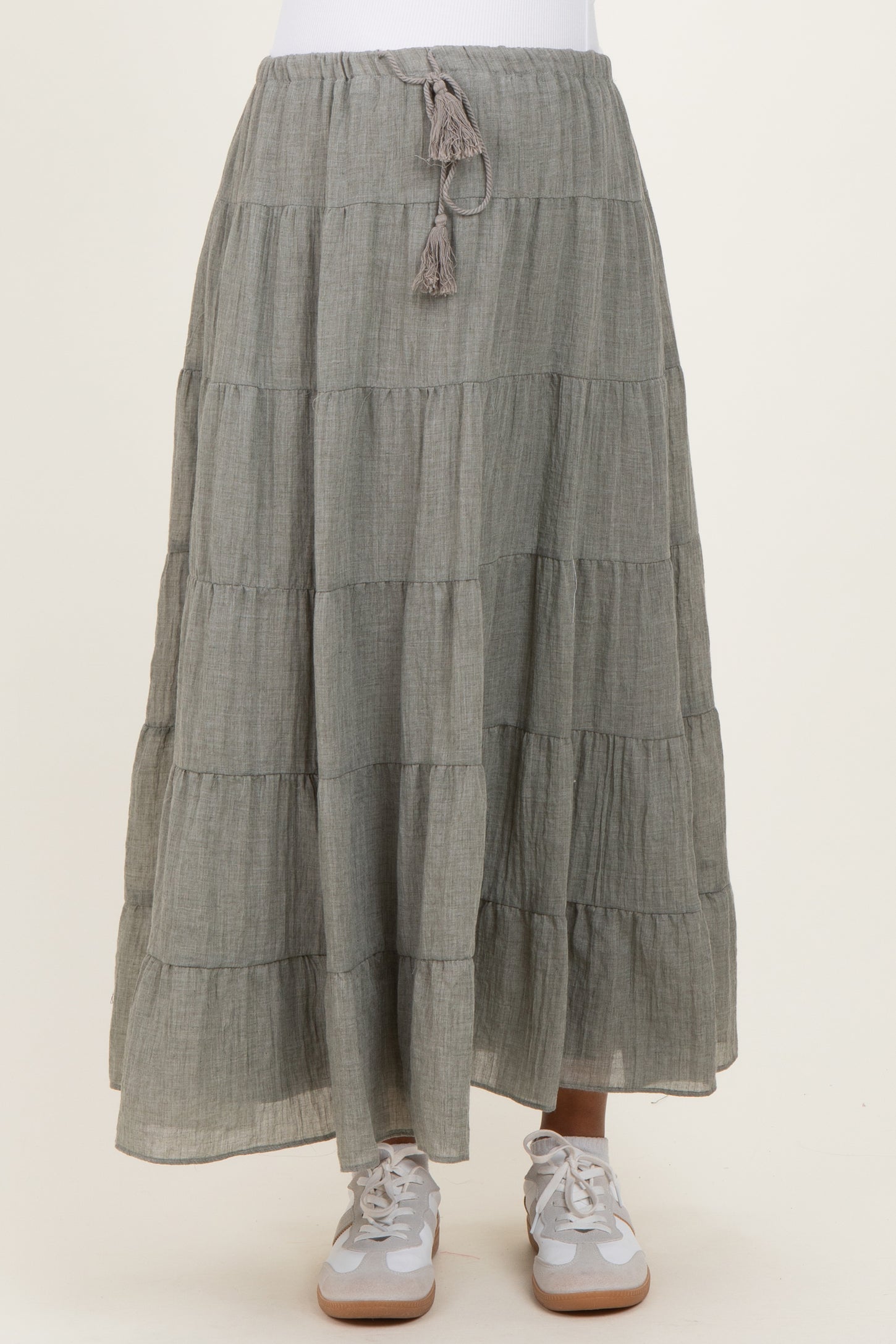 maternity wear gray tiered maxi skirt with adjustable drawstring and tassel detail, paired with white sneakers