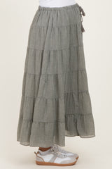 woman wearing a gray tiered maternity maxi skirt with a drawstring waist and paired with white sneakers