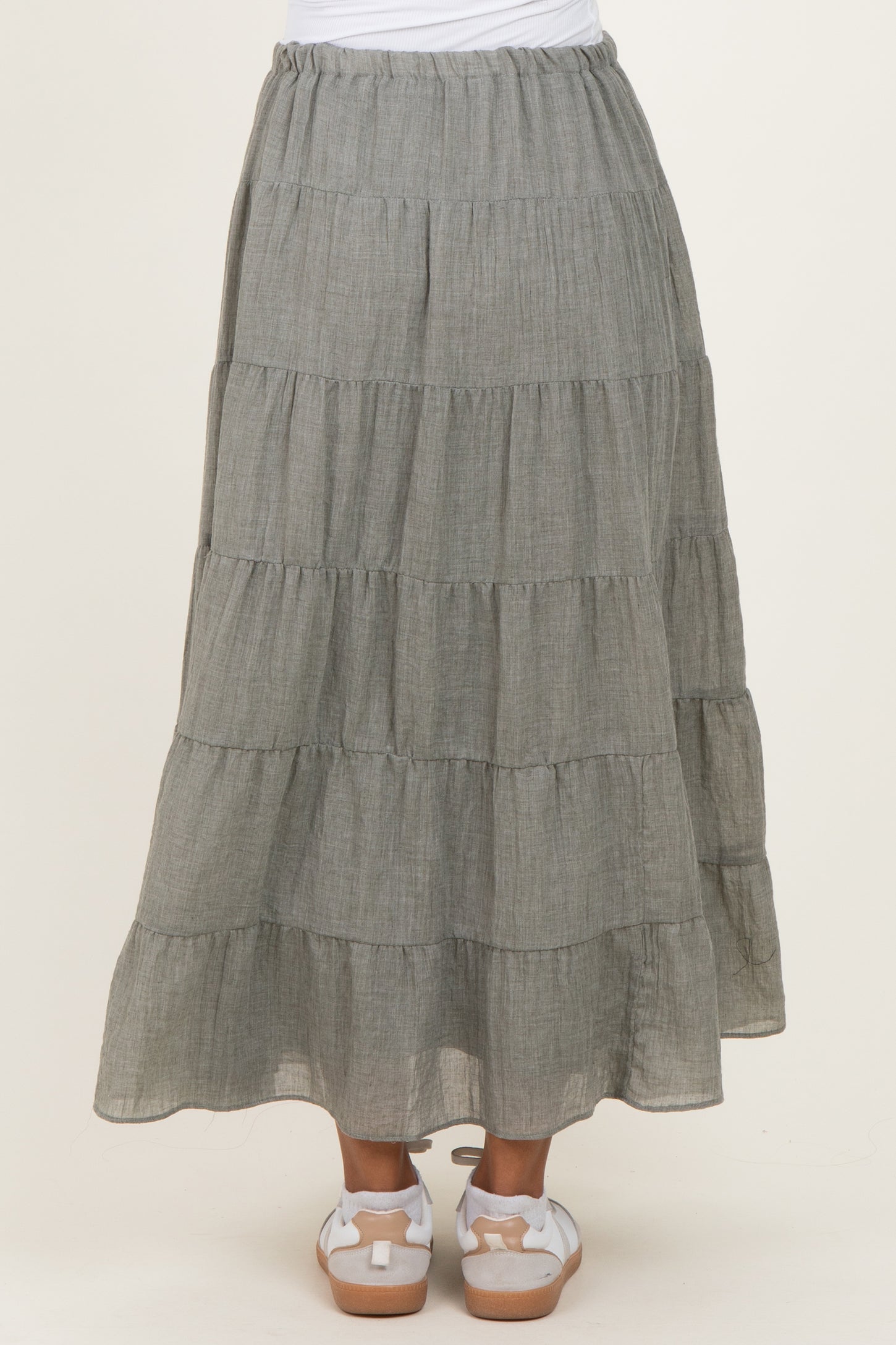 woman wearing a long gray tiered maxi skirt, showcasing a relaxed fit and flowy style, maternity wear