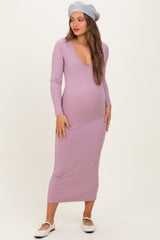 woman wearing a lavender ribbed maternity dress with a deep v-neck and long sleeves, showcasing her baby bump