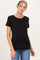woman wearing a black short sleeve maternity top with a fitted style and a baby bump visible