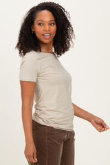 woman wearing a light beige short sleeve top with fitted style and a relaxed fit, paired with brown corduroy pants