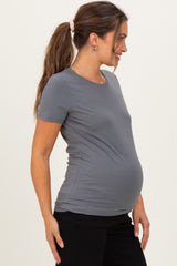 woman wearing a grey short sleeve maternity t-shirt, showing a visible baby bump