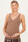 woman wearing a brown maternity sleeveless ribbed tank top and holding her baby bump