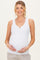 woman wearing a white maternity tank top and holding her baby bump