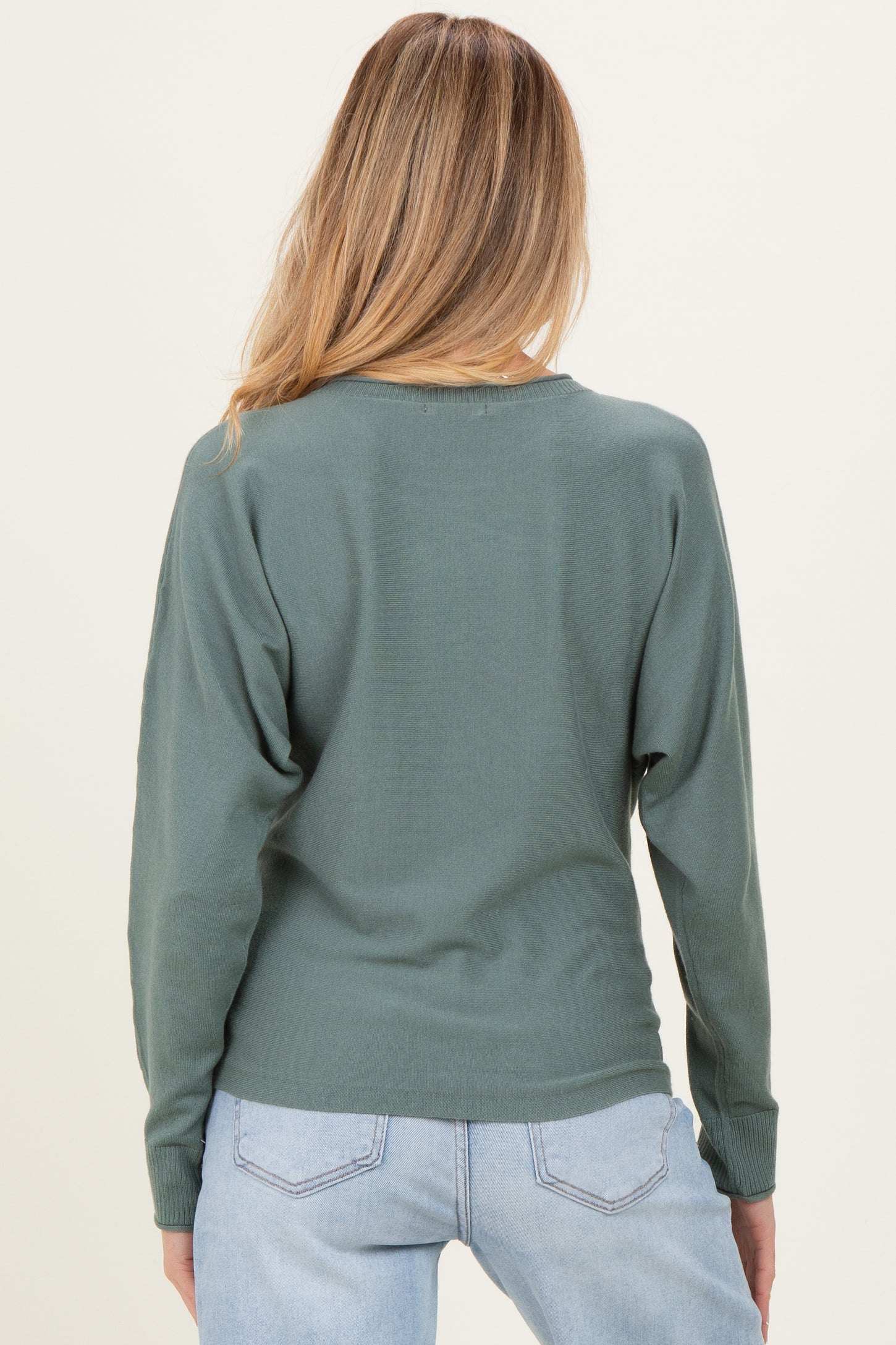 woman wearing a green back view long sleeve maternity top with a relaxed fit and dropped shoulders