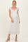 woman wearing a white floral maternity dress with a square neckline and a baby bump