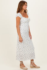 woman wearing a white floral maxi dress with puff sleeves and a square neckline, paired with espadrille wedges