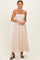 woman wearing a blush pink maxi dress with spaghetti straps and floral embroidery details